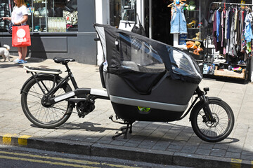 A rickshaw bike with a rain roof in the city