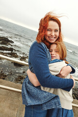 Hug, smile and girl with mom for ocean, bonding or relax together for relationship. Family, portrait and mother with daughter on holiday outdoor with love, beach and travel for weekend or vacation