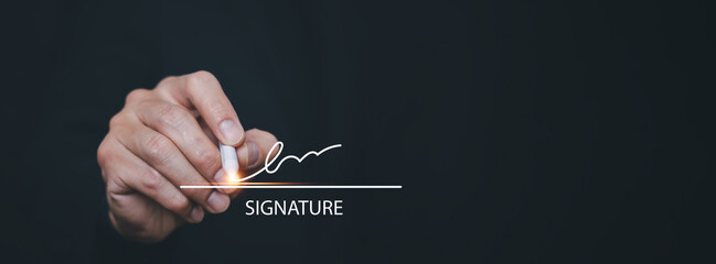 Hand holding a digital pen signing an electronic signature on dark background. Concept of digital contract, e-signature, online document approval and modern business workflow.