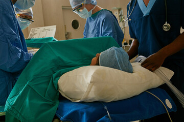 Medical, surgery and teamwork with doctors in scrubs together for procedure on patient. Emergency, operation and surgical with people operating in hospital for healthcare, life rescue or support