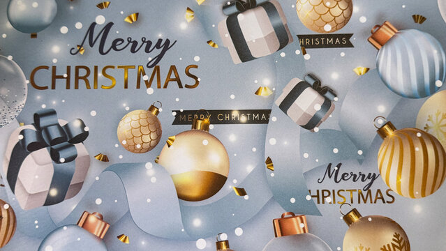 A festive Christmas background with gold and blue ornaments, gift boxes, confetti, and &ldquo;Merry Christmas&rdquo; text on a soft winter backdrop, perfect for holiday designs