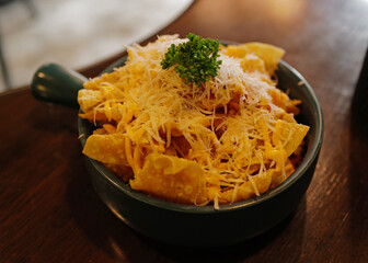 Close up deep fried Wonton topped with Mozzarella cheese and crispy bacon