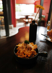 Close up deep fried Wonton topped with Mozzarella cheese and crispy bacon