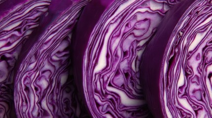 Obraz premium Slices of purple cabbage arranged side by side showing the intricate patterns, colors, and textures of the vegetable