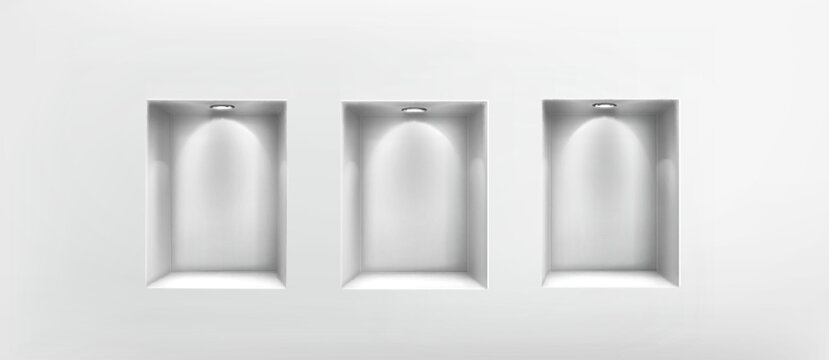 Fototapeta Empty white wall niches with led spotlights and shadow depth in 3d room interior. Blank shelf boxes illuminated by ceiling light for museum gallery exhibition or retail product display frame mockup.