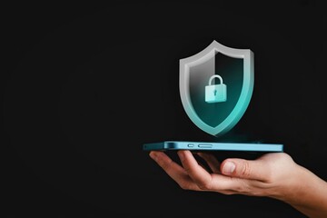 Digital security shield hologram appears above smartphone