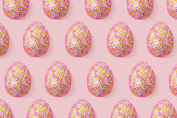 Decorative easter eggs in colorful sequins as minimal trend repeat pattern pastel pink color. Pop art still life photo with sparkling rhinestones eggs, spring easter holiday concept, modern design.