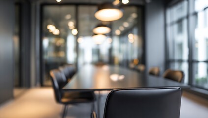 Empty modern conference room with blurred warm overhead lighting.