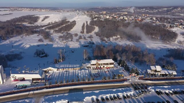 Aerial lateral drone shot over snowy ski landscape