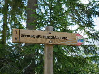 Wooden Hiking Sign Pointing To Lake Carezza Trail, Italy