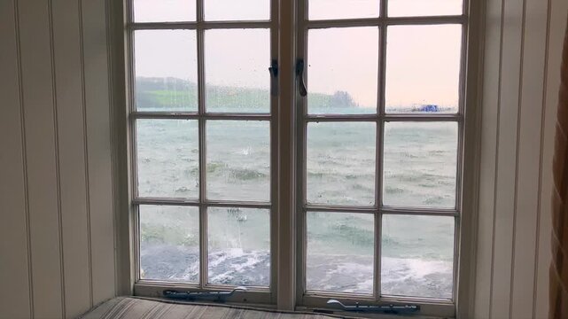  A rough sea outside a window