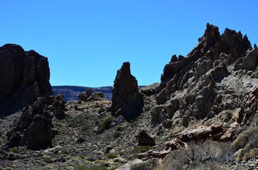 Fototapeta premium Scenic view of volcanic rock formations in desert during sunny day, Teide National Park, Tenerife