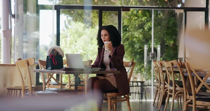 Woman, typing and drinking coffee in cafe with laptop for remote work, journalism idea and news report. Freelancer, person and beverage in restaurant with computer, editing article, blog and review.