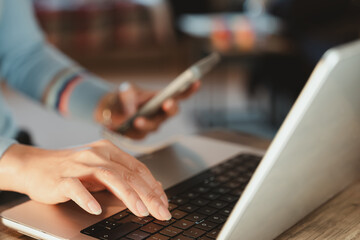 Person hands using laptop and smartphone for online customer service, contact us form, tax payment, bill pay, or account support. Perfect for fintech, service apps, and websites