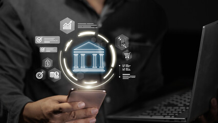 Businessman using smartphone with virtual digital banking and financial icons.