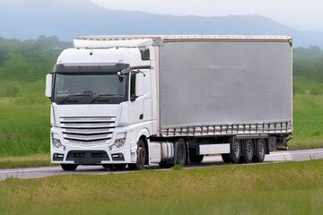 Modern logistics trailer driving on sunny highway