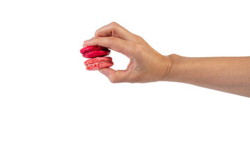 Pink and red macarons in hand on transparent background