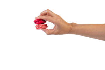 Pink and red macarons in hand on transparent background