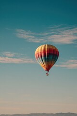 Fototapeta premium Calm, minimal scene with a lone hot air balloon in expansive blue atmosphere
