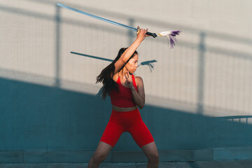 Chinese young woman practicing wushu kung fu.
