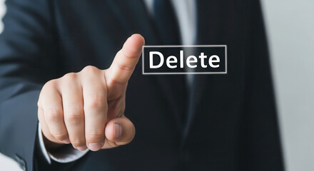 Businessman in formal attire is pressing a digital button labeled 'Delete' on a touchscreen, symbolizing data management and decision-making in a corporate environment