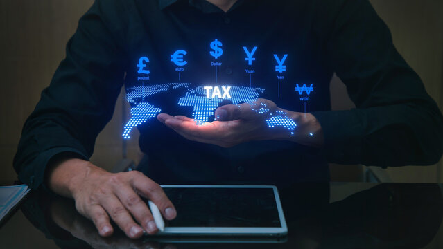 Focused businessman uses finance hologram for international tax policy. This global business technology concept shows money - Powered by Adobe