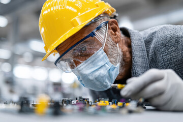 Engineer inspecting small robotics components carefully
