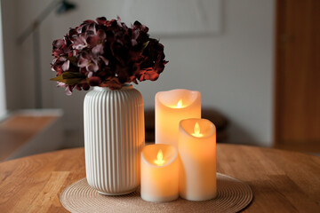 Cozy autumn home interior with warm candlelight and LED decor creating a calm hygge atmosphere