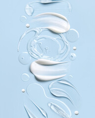 samples of cosmetic care products smear of cream and gel texture on a light blue background, moisturizing and skin care concept