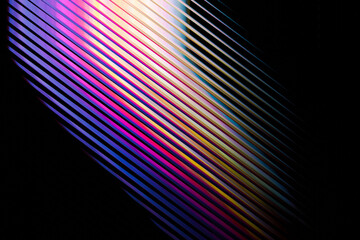 Abstract diagonal lines with vibrant gradient colors and subtle light reflections on a dark background