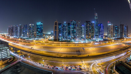 Aerial view of Jumeirah lakes towers skyscrapers day to night timelapse with traffic on sheikh...