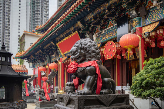 Wong Tai Sin Temple building and hanging lanterns located in Hong Kong City. Photo taken on a cloudy day
