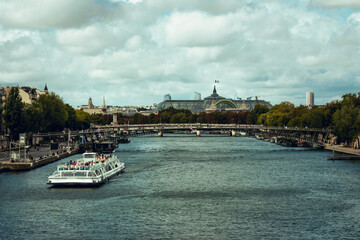 View of Grand Palais Paris, from Pont Royal bridge, Paris, France. Historical landmark. Seine river tour ship in foreground. September 11th, 2025.