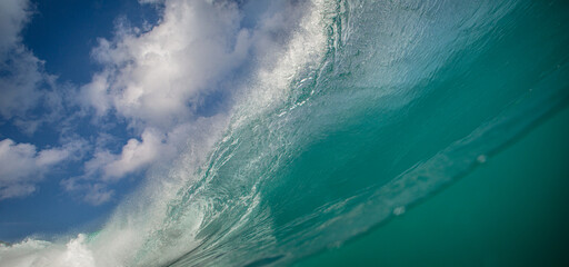 Big crest of breaking colorful ocean wave falling down, surfing water

