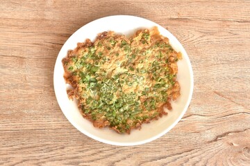 crispy fried egg omelets stuffed chop yard long bean Chinese food on dish  