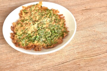 crispy fried egg omelets stuffed chop yard long bean Chinese food on dish  