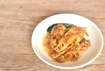 spicy fried slice pickled bamboo shoot with beef meat in curry sauce on plate