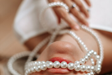 Beautiful chic elegant fashion accessories details of white pearl beads and woman's lips