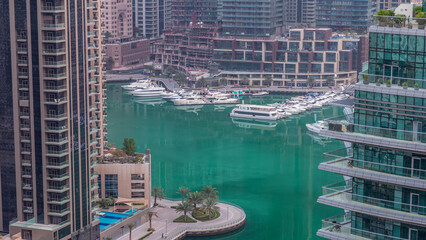 Waterfront promenade in Dubai Marina aerial night to day timelapse. Dubai, United Arab Emirates