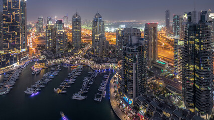 Aerial top view of Dubai Marina day to night timelapse. Modern towers and traffic on the road