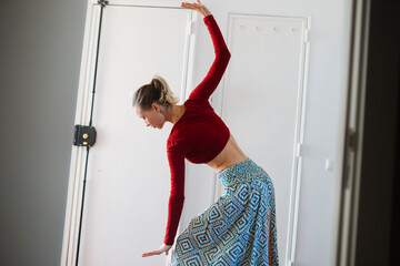 Studio session with female dancer engaging in flexibility exercise