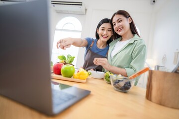 Friends share cooking ideas while preparing a meal in a bright kitchen during the day with fresh ingredients on the counter