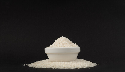 Grated coconut powder. Dry coco flakes pile, shredded desiccated coconut, tropical fruit chips