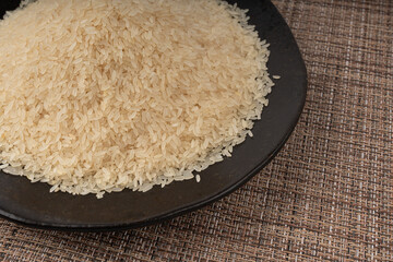 White parboiled rice grains. Dry uncooked ponni rice, small organic basmati