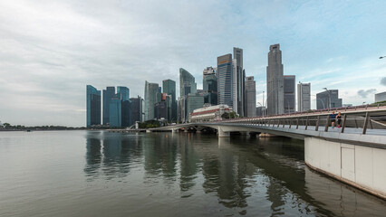 Naklejka premium Esplanade bridge and downtown core skyscrapers in the background Singapore night to day timelapse