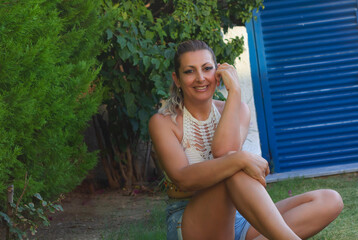portrait of a beautiful young woman smiling at camera in the garden