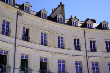 Naklejka premium hotel l'hermine in city vannes port curved historical stone facade with dormer windows against a clear sky