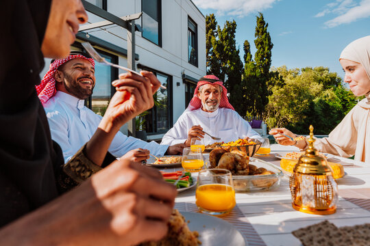 Arab multigenerational family enjoying outdoor meal together