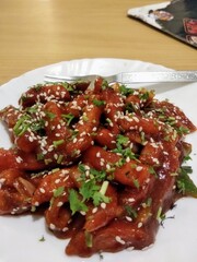 crispy honey chilli potato with sesame seeds