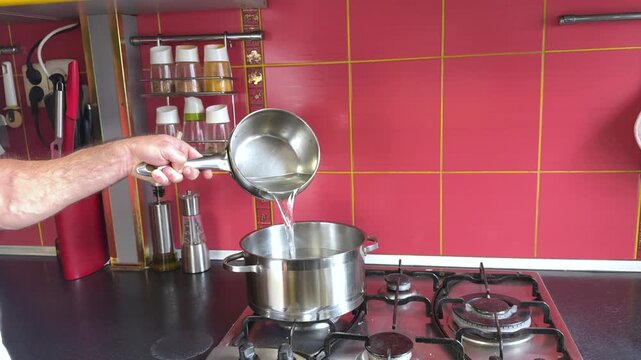 Preparing sugar syrup for soaking cake crust. Professional chef pouring water. High quality 4k footage